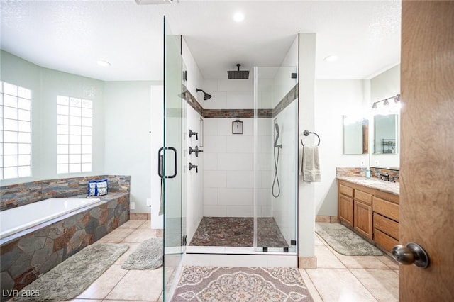 bathroom featuring vanity, a stall shower, a garden tub, and visible vents