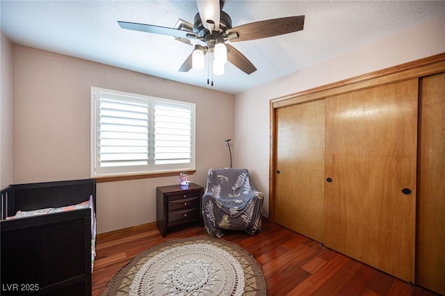 bedroom with ceiling fan, a closet, and wood finished floors