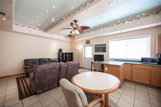 dining area featuring baseboards, a ceiling fan, light tile patterned flooring, and visible vents