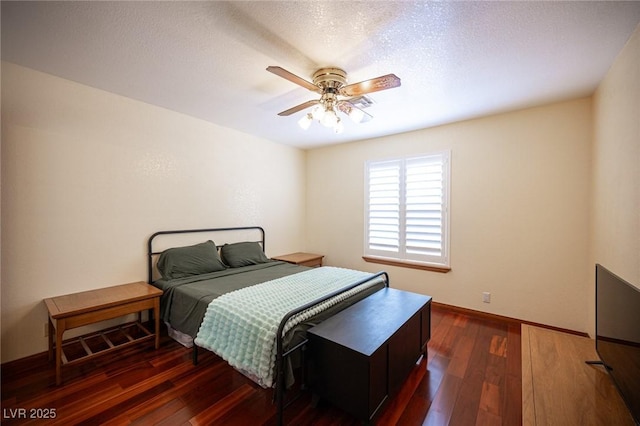 bedroom with baseboards, a textured ceiling, ceiling fan, and dark wood-style floors