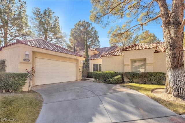 6961 Emerald Springs Ln, Las Vegas, NV 89113 - mediterranean / spanish house featuring a tiled roof, concrete driveway, stucco siding, and an attached garage