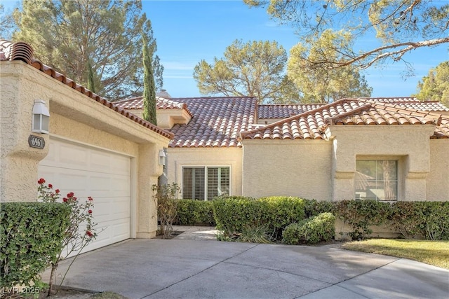 6961 Emerald Springs Ln, Las Vegas, NV 89113 - view of front of property with concrete driveway, stucco siding, an attached garage, and a tile roof