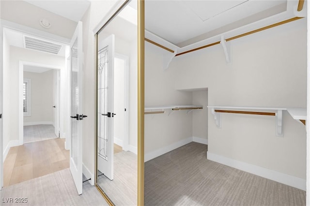 6961 Emerald Springs Ln, Las Vegas, NV 89113 - walk in closet featuring light carpet
