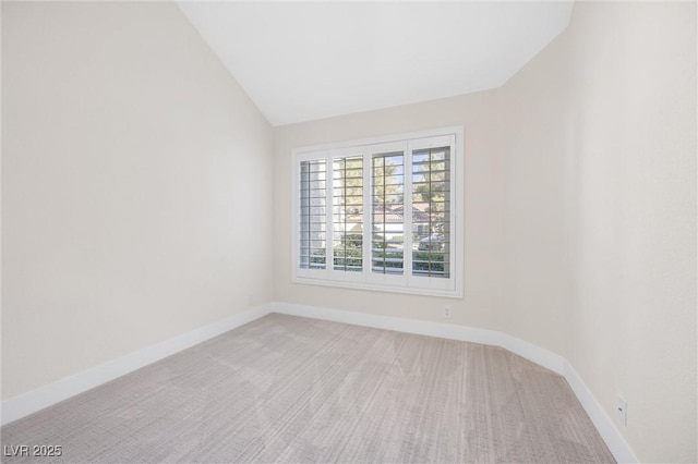 6961 Emerald Springs Ln, Las Vegas, NV 89113 - spare room featuring light colored carpet, baseboards, and lofted ceiling