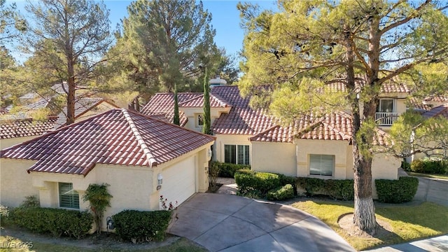 6961 Emerald Springs Ln, Las Vegas, NV 89113 - mediterranean / spanish-style home with stucco siding, a tile roof, driveway, and an attached garage