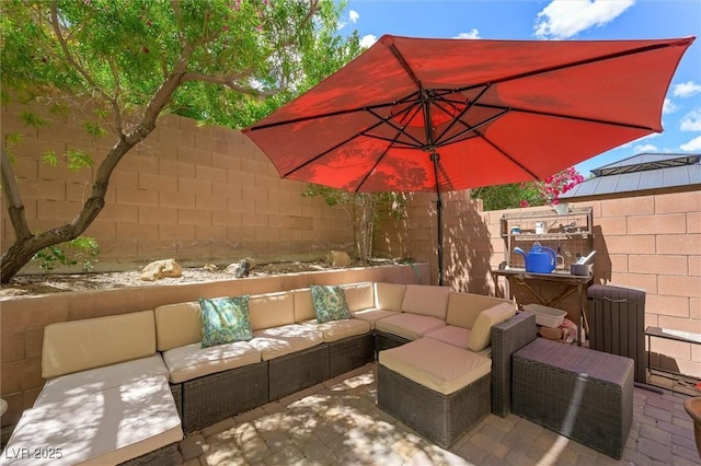 view of patio / terrace featuring fence and outdoor lounge area