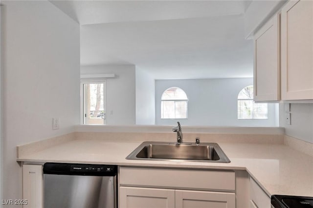 kitchen with range with electric stovetop, light countertops, white cabinets, a sink, and dishwasher