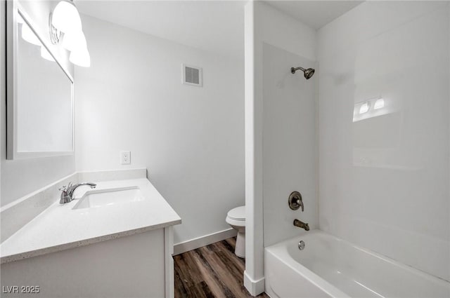full bath featuring visible vents, wood finished floors, vanity, toilet, and  shower combination