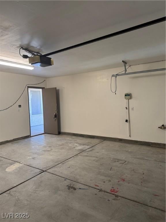 garage featuring baseboards and a garage door opener
