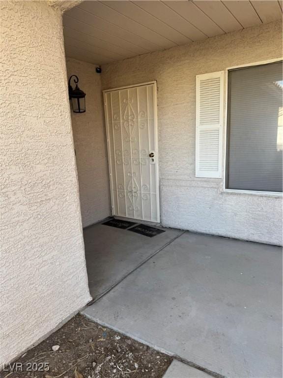 doorway to property with stucco siding