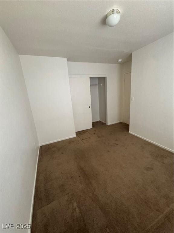 carpeted spare room with baseboards