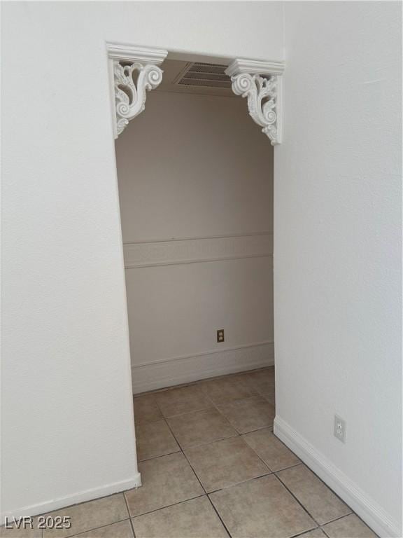 interior space with baseboards and light tile patterned floors