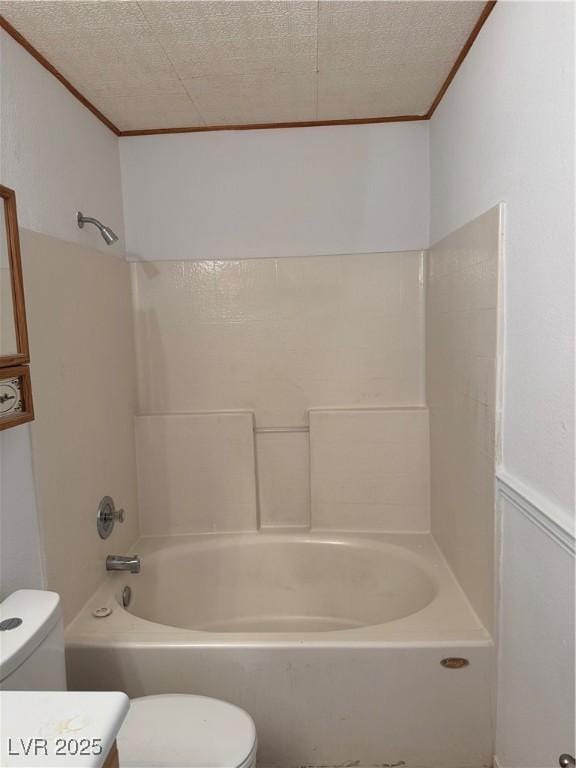 bathroom with crown molding, toilet, and shower / washtub combination