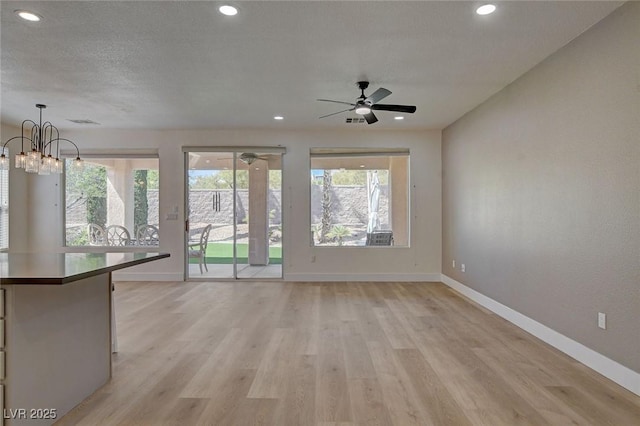 4379 Bella Cascada St, Las Vegas, NV 89135 - unfurnished living room featuring recessed lighting, baseboards, light wood finished floors, and ceiling fan with notable chandelier