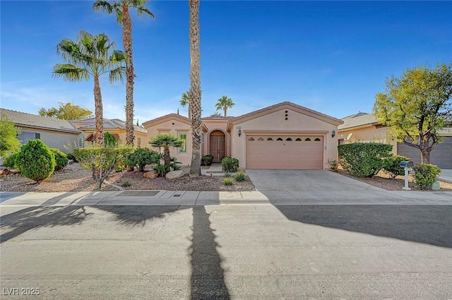 4379 Bella Cascada St, Las Vegas, NV 89135 - mediterranean / spanish house featuring an attached garage, concrete driveway, and stucco siding