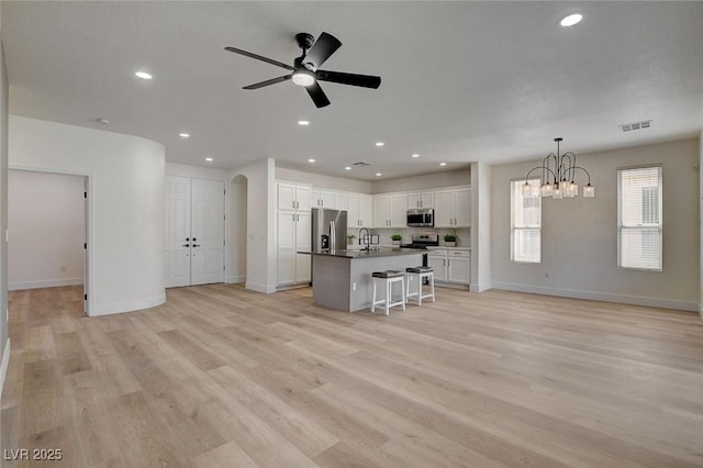 4379 Bella Cascada St, Las Vegas, NV 89135 - kitchen featuring appliances with stainless steel finishes, a sink, ceiling fan with notable chandelier, open floor plan, and visible vents