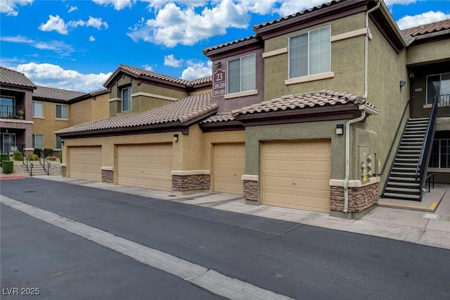 6868 Sky Pointe Dr Unit 1089, Las Vegas, NV 89131 - view of property with stairway, a tile roof, and stone siding
