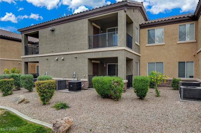 6868 Sky Pointe Dr Unit 1089, Las Vegas, NV 89131 - rear view of property featuring central AC unit, stucco siding, a tile roof, and a balcony