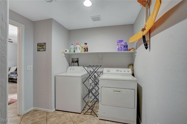 6868 Sky Pointe Dr Unit 1089, Las Vegas, NV 89131 - washroom with laundry area, visible vents, light tile patterned flooring, baseboards, and separate washer and dryer