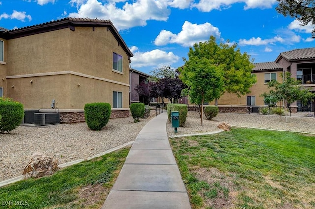 6868 Sky Pointe Dr Unit 1089, Las Vegas, NV 89131 - view of side of property with central AC unit, stucco siding, and a yard