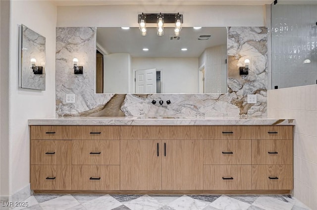 bathroom featuring vanity, visible vents, backsplash, and marble finish floor