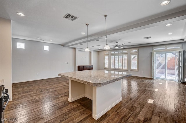 kitchen featuring open floor plan, visible vents, dark wood finished floors, and a center island