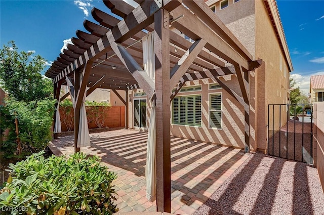 view of patio featuring fence and a pergola