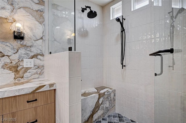 full bathroom with a tile shower and tile walls