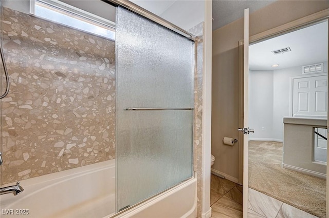 bathroom with visible vents, enclosed tub / shower combo, and toilet
