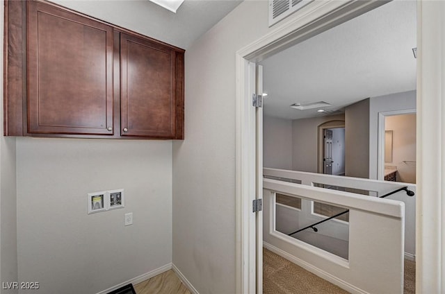 clothes washing area featuring baseboards, cabinet space, hookup for a washing machine, and visible vents