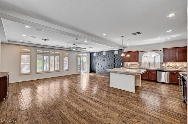 kitchen with visible vents, backsplash, dark wood-style flooring, and dishwasher