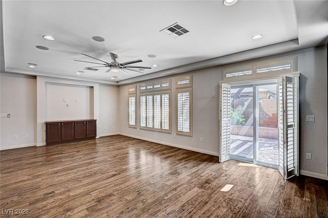 unfurnished living room featuring visible vents, baseboards, ceiling fan, and wood finished floors