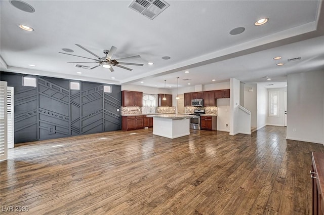 kitchen featuring visible vents, open floor plan, plenty of natural light, and stainless steel appliances