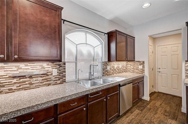 kitchen featuring stainless steel dishwasher, dark wood-style flooring, decorative backsplash, and a sink
