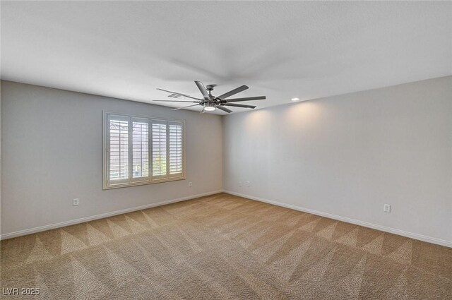 unfurnished room with a ceiling fan, baseboards, and light colored carpet