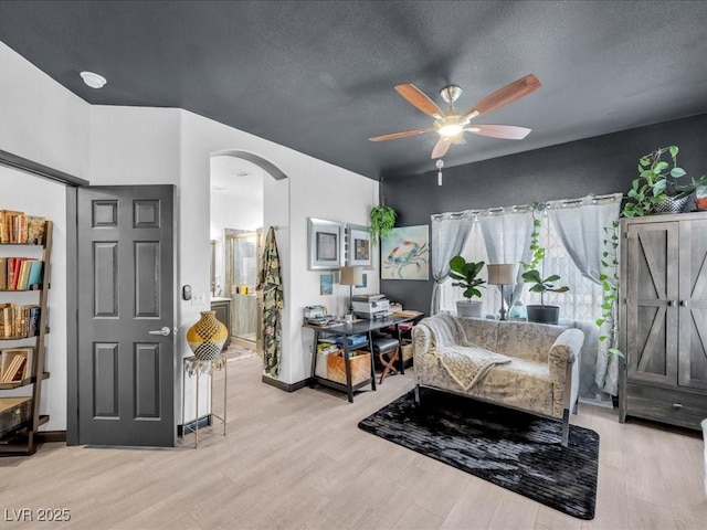 6324 Desert Leaf St Unit 3, North Las Vegas, NV 89081 - sitting room featuring ceiling fan, a textured ceiling, arched walkways, and wood finished floors