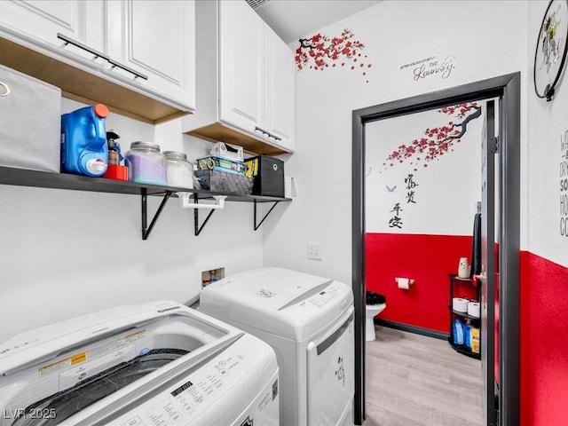 6324 Desert Leaf St Unit 3, North Las Vegas, NV 89081 - laundry room with cabinet space, light wood-type flooring, and washer and dryer