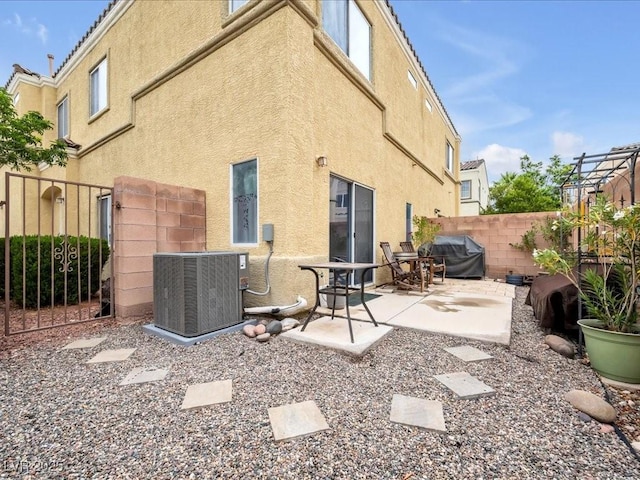 6324 Desert Leaf St Unit 3, North Las Vegas, NV 89081 - back of property featuring central air condition unit, fence, stucco siding, and a patio area