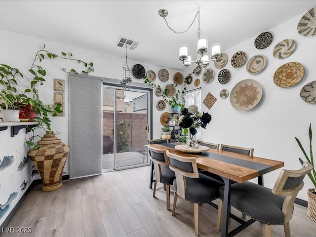 6324 Desert Leaf St Unit 3, North Las Vegas, NV 89081 - dining room with a chandelier, light wood-type flooring, and visible vents