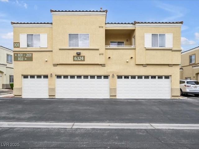 6324 Desert Leaf St Unit 3, North Las Vegas, NV 89081 - multi unit property featuring an attached garage, stucco siding, and a tile roof