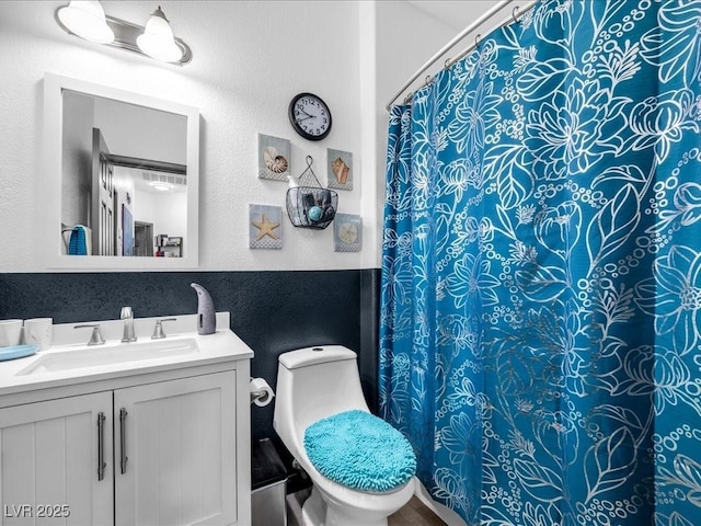 6324 Desert Leaf St Unit 3, North Las Vegas, NV 89081 - bathroom with toilet, a shower with shower curtain, vanity, and a textured wall