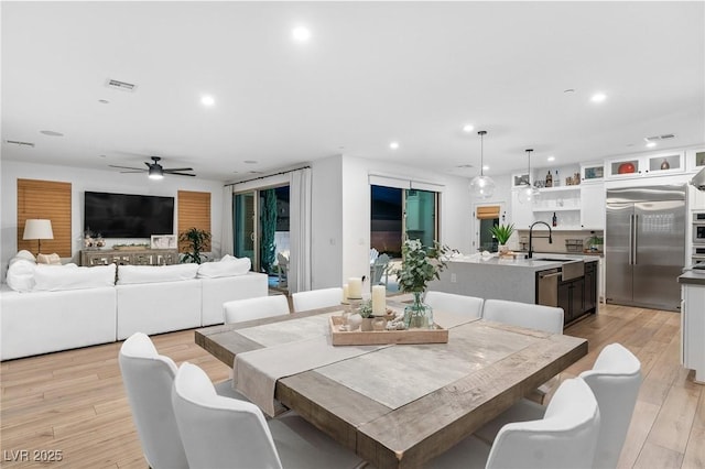 dining room featuring a ceiling fan, visible vents, light wood-style flooring, and recessed lighting