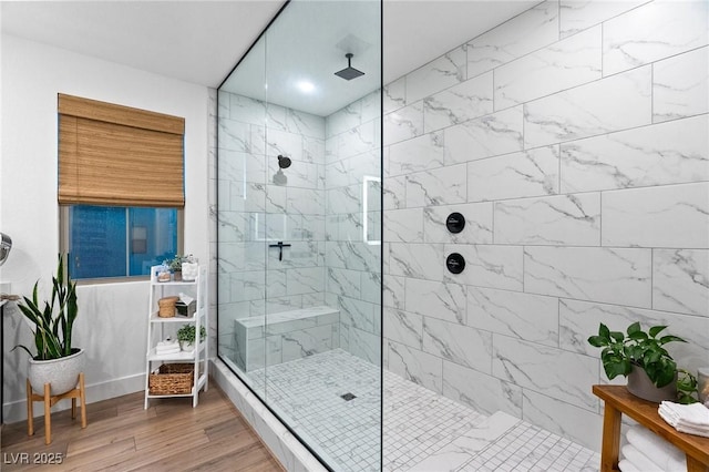 bathroom featuring tiled shower and wood finished floors