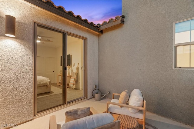 exterior space featuring stucco siding and a tile roof