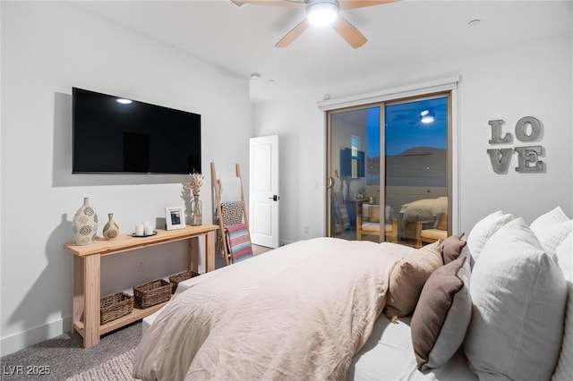carpeted bedroom featuring baseboards and ceiling fan