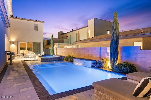 view of pool featuring fence, a patio, and a pool with connected hot tub