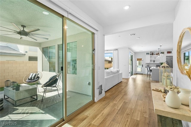 interior space featuring visible vents, light wood-style flooring, and plenty of natural light