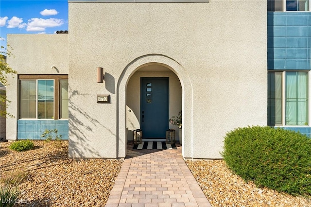 entrance to property with stucco siding