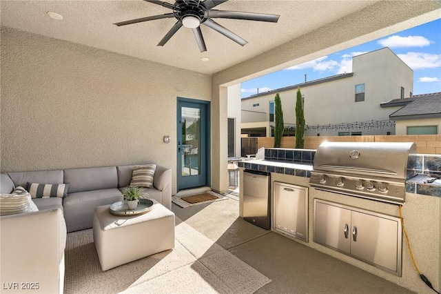 view of patio / terrace with fence, an outdoor kitchen, ceiling fan, grilling area, and an outdoor living space