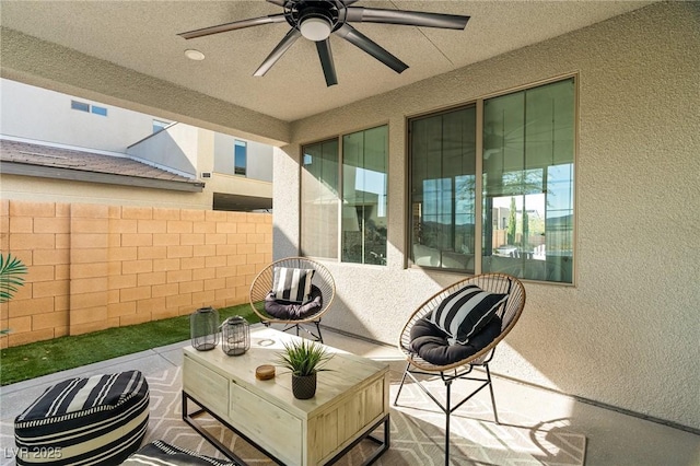 view of patio / terrace with ceiling fan, visible vents, and fence